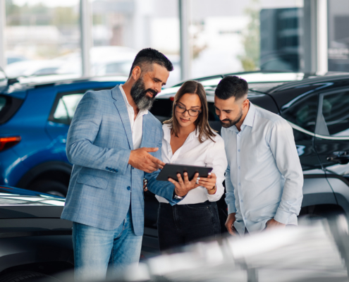 People At Dealership Looking At Tablet