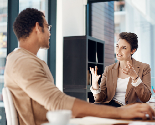 Two Workers Talking In Office