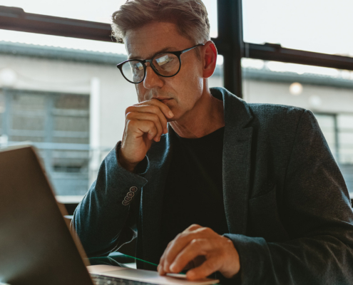 Business Professional Working On Laptop In Office